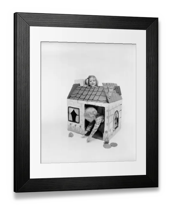 Framed Print : Toys: Children playing with a Wendy house made out of cardboard Framed Print : Toys: Children playing with a Wendy house made out of cardboard