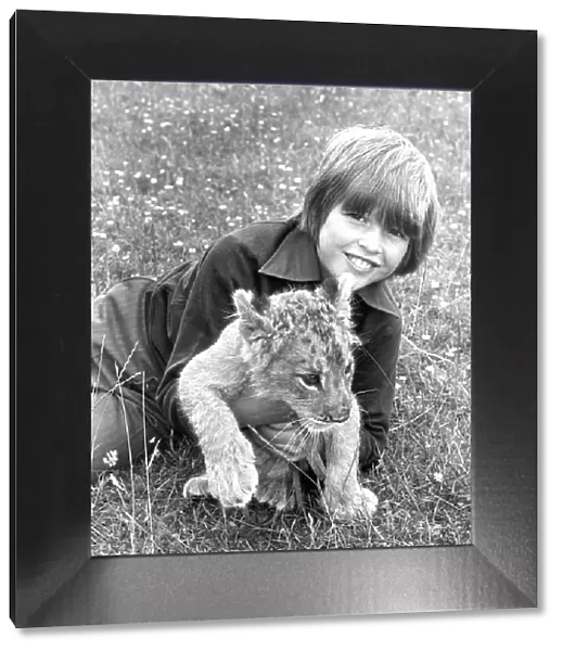 Not all big cats are fearsome as this boy found out with 12 week old lion cub Khan in