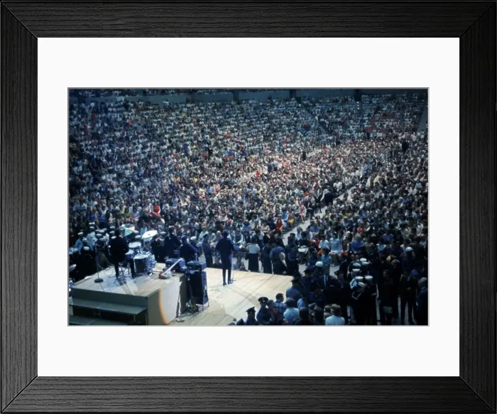 Framed Print : British pop group The Beatles playing to a huge crowd out a packed out music venue during Framed Print : British pop group The Beatles playing to a huge crowd out a packed out music venue during