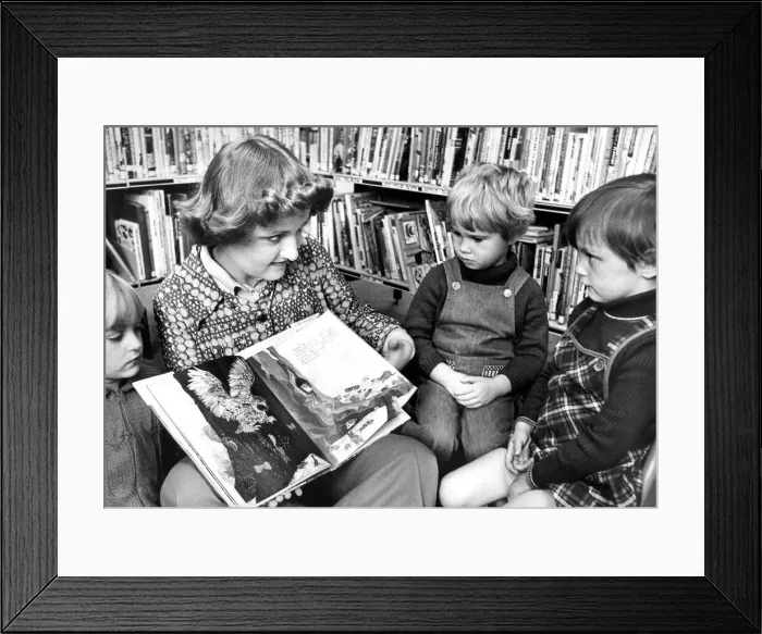 Framed Print : Library Assistant Christine Maley telling a story to Karen Miller Framed Print : Library Assistant Christine Maley telling a story to Karen Miller