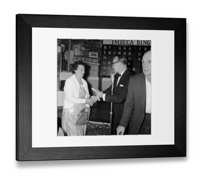 Framed Print : Newsagent Mrs Helen Retter picks up her £83 prize money after a winning night out