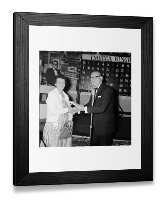 Framed Print : Newsagent Mrs Helen Retter picks up up her £83 prize money after a winning night