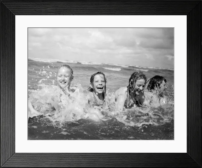 Framed Print : Four children enjoy a swim in the sea at Blackpool beach in the summer holidays Framed Print : Four children enjoy a swim in the sea at Blackpool beach in the summer holidays