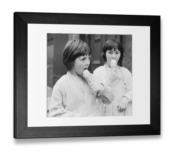 Framed Print : Two young girls enjoy eating ice creams 9th April 1962