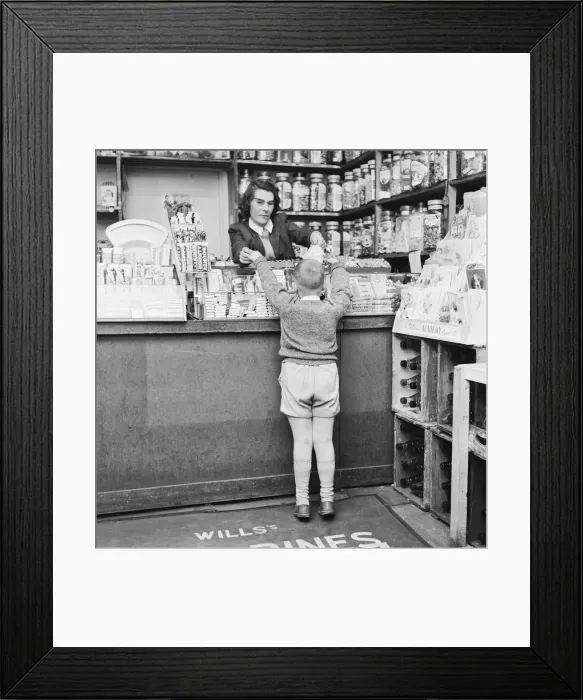 Framed Print : Child buying sweets at shop counter 9th April 1962 Framed Print : Child buying sweets at shop counter 9th April 1962