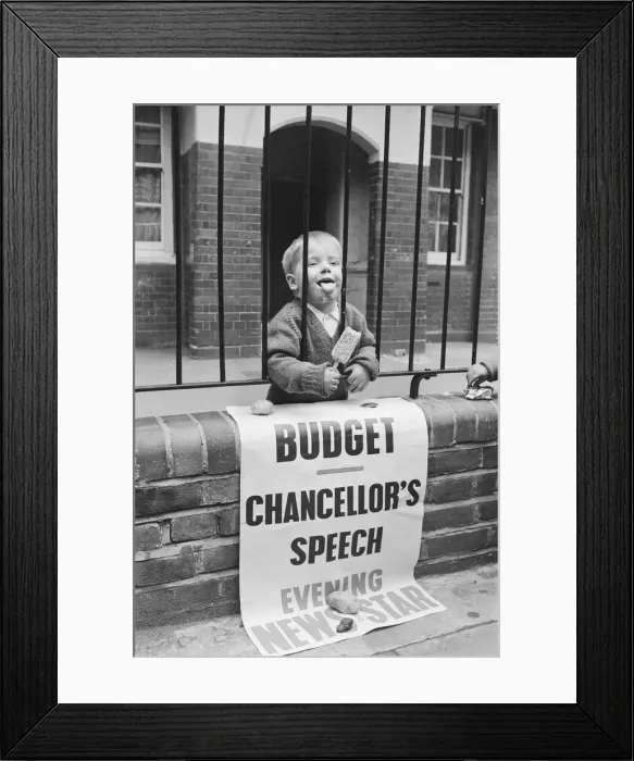 Framed Print : Child eating ice cream from behind school railings on budget day Framed Print : Child eating ice cream from behind school railings on budget day