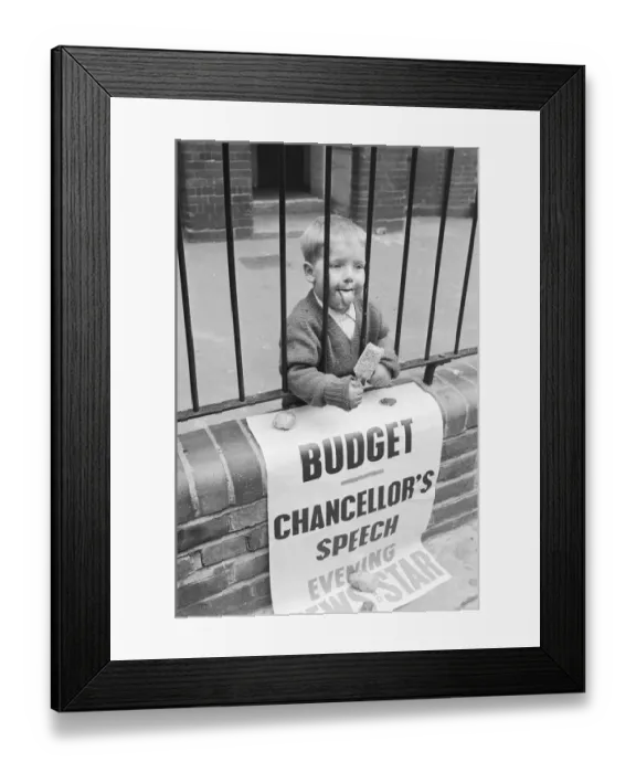 Framed Print : Child eating ice cream from behind school railings on budget day