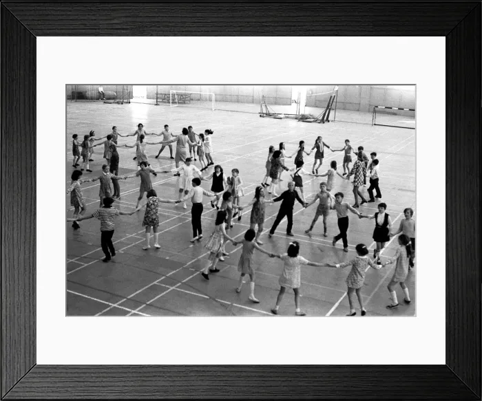 Framed Print : School children take part in an end of school year dance at the Lightfoot Stadium in