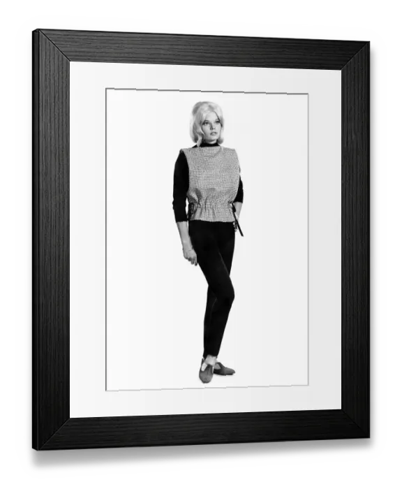 Framed Print : Reveille Fashions 1964: Dianna Terry modeling a bib top with black slacks Framed Print : Reveille Fashions 1964: Dianna Terry modeling a bib top with black slacks