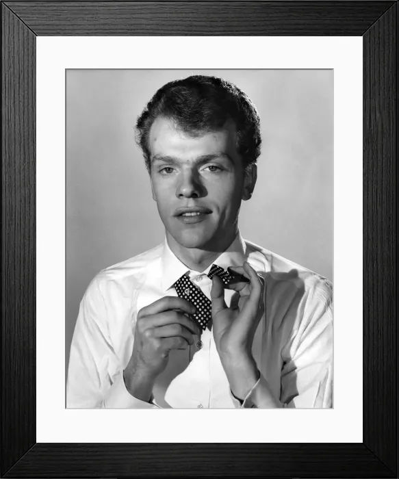Framed Print : Reveille Fashions: Peter Hamilton-Davies attempts to tie a pollka dot bow tie