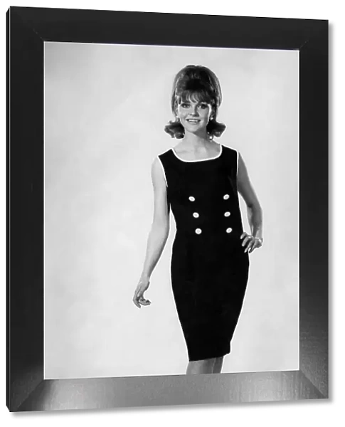 Reveille Fashions. Ann Roberts modeling a sleeveless summer dress. May 1964 P007592