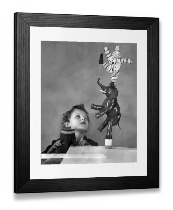 Framed Print : Boy playing with Humpty Dumpty Circus toys for Christmas December 1924 Framed Print : Boy playing with Humpty Dumpty Circus toys for Christmas December 1924