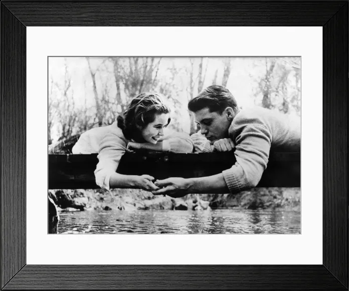Framed Print : Love and Romance. Couple holding hands on a log across a stream December 1958 Framed Print : Love and Romance. Couple holding hands on a log across a stream December 1958