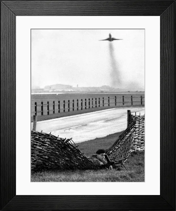 Framed Print : Army at London Airport during a terror alert. One of the soldiers concealed by a fence Framed Print : Army at London Airport during a terror alert. One of the soldiers concealed by a fence