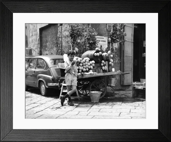 Framed Print : A young boy of Naples in Southern Italy selling goods on the side of the road Framed Print : A young boy of Naples in Southern Italy selling goods on the side of the road
