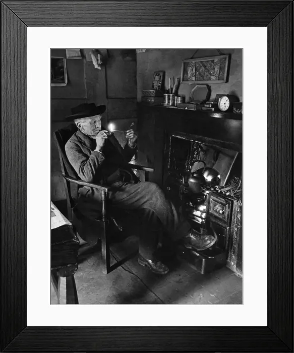 Framed Print : Trinity Hospital foundation. Mr. H South lights his pipe in preparation for a Framed Print : Trinity Hospital foundation. Mr. H South lights his pipe in preparation for a