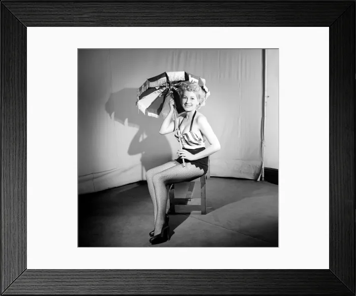 Framed Print : Woman wearing bra and skirt holding parasol. 1959