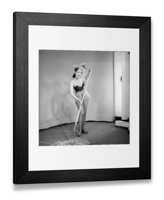 Framed Print : Woman dressed in grass skirt as girl Friday. 1959