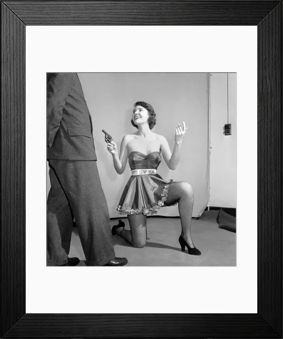 Framed Print : Miss Leap Year: Belinda Penelope seen here proposing to boyfriend holding a gun