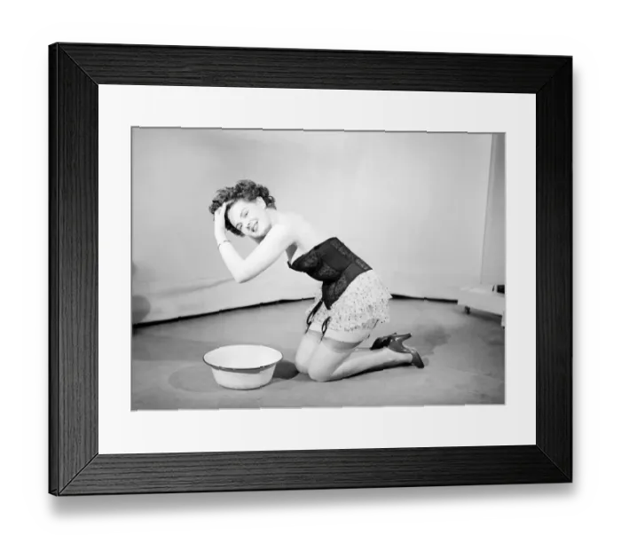 Framed Print : Woman wearing corsett washing hair. 1959