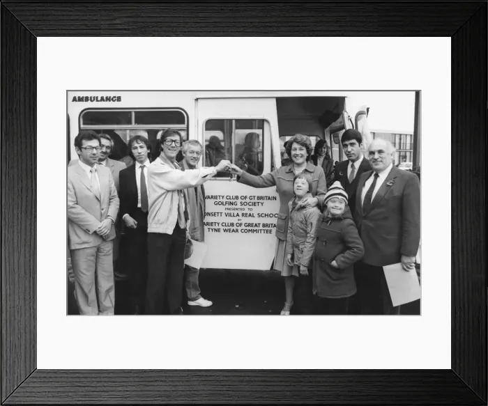 Framed Print : The Shadowss Hank Marvin at the bus handover to Villa Real School headteacher Elsie Framed Print : The Shadowss Hank Marvin at the bus handover to Villa Real School headteacher Elsie