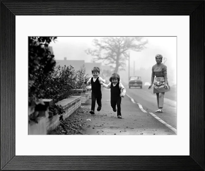 Framed Print : Children: Boy and girl: Young twins holding hands, running with happy expressions