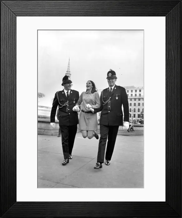 Framed Print : Woman being held up by two policemen in Trafalgar Square, London. October 1969 Z10351 Framed Print : Woman being held up by two policemen in Trafalgar Square, London. October 1969 Z10351