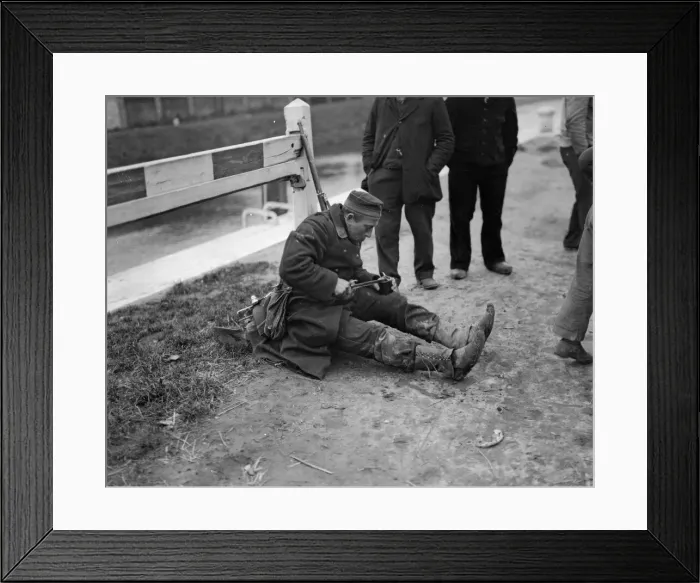 Framed Print : A Belgian soldier tired out with much marching, sits down by the roadside for a meal