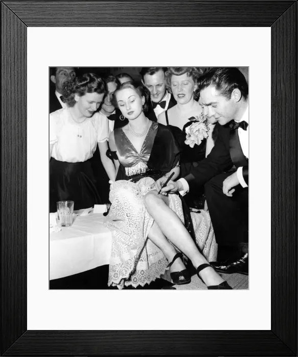 Framed Print : Film star Richard Todd signs an autograph on Beryl Butterworth Framed Print : Film star Richard Todd signs an autograph on Beryl Butterworth