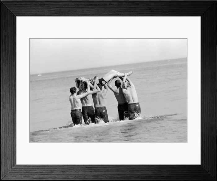 Framed Print : Isle of Man TT Races 1967. TT Riders dunk 19 year old Joyce Milton in the sea after Framed Print : Isle of Man TT Races 1967. TT Riders dunk 19 year old Joyce Milton in the sea after