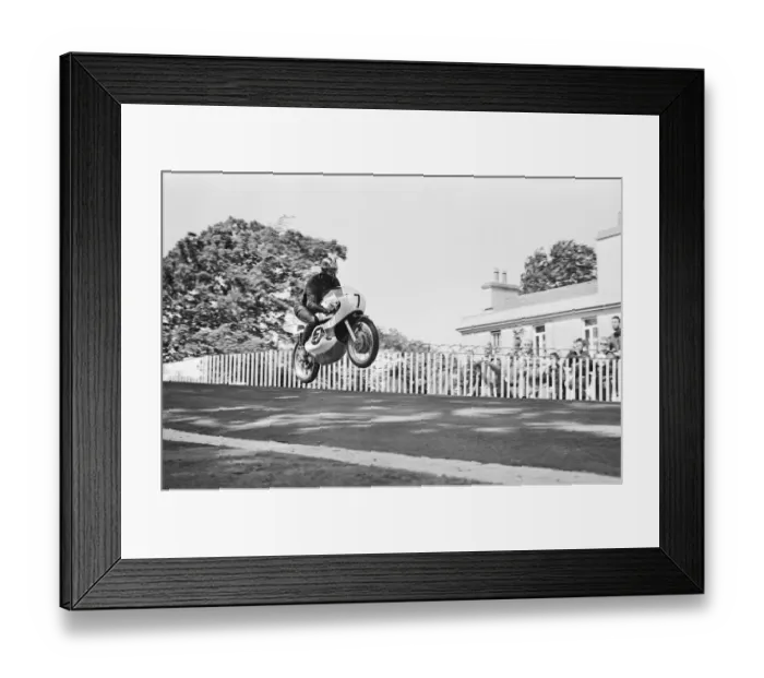 Framed Print : Isle of Man TT Races - Junior International. Winner Jim Redman goes over Ballaugh