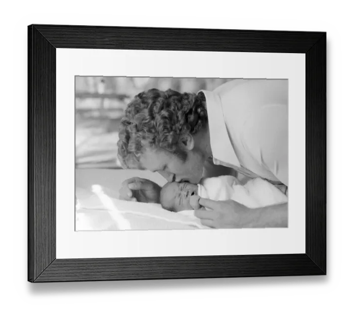 Framed Print : Former British European Heavyweight champion boxer Joe Bugner kisses his new born baby Framed Print : Former British European Heavyweight champion boxer Joe Bugner kisses his new born baby
