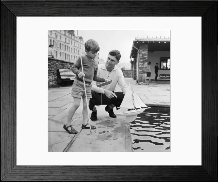 Framed Print : TT Rider Jim Redman with his son at the Douglas Promenade boating pool Framed Print : TT Rider Jim Redman with his son at the Douglas Promenade boating pool