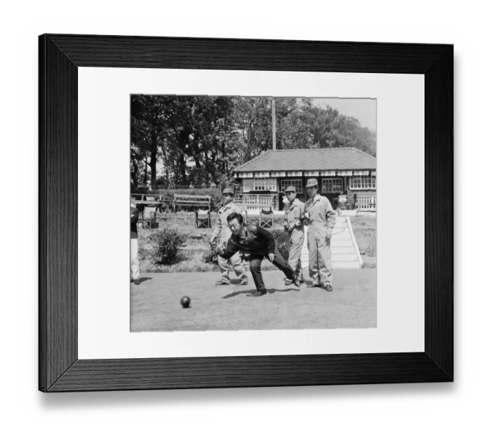 Framed Print : Japanese rider Shimazaki playing bowls with his team of mechanics watching Framed Print : Japanese rider Shimazaki playing bowls with his team of mechanics watching