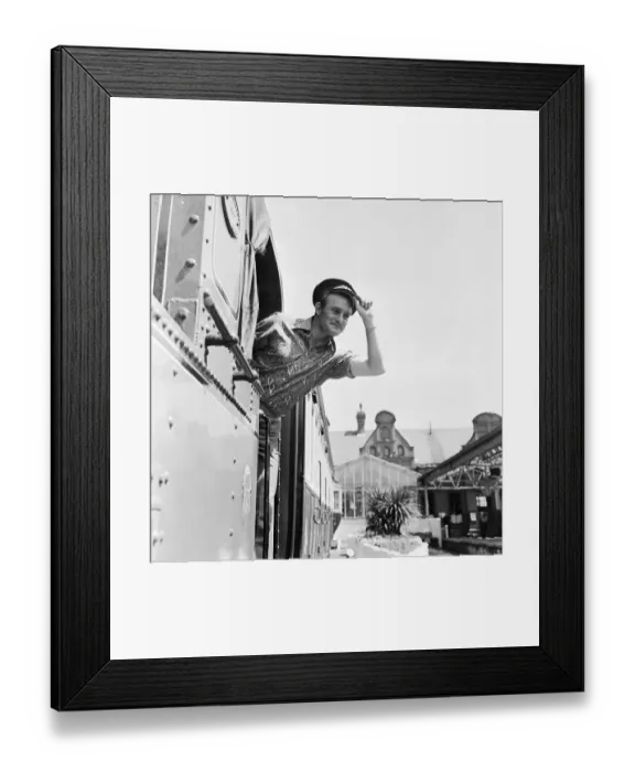 Framed Print : Isle of Man TT Races. Rider Mike Hailwood wearing a drivers cap on a Manx train Framed Print : Isle of Man TT Races. Rider Mike Hailwood wearing a drivers cap on a Manx train