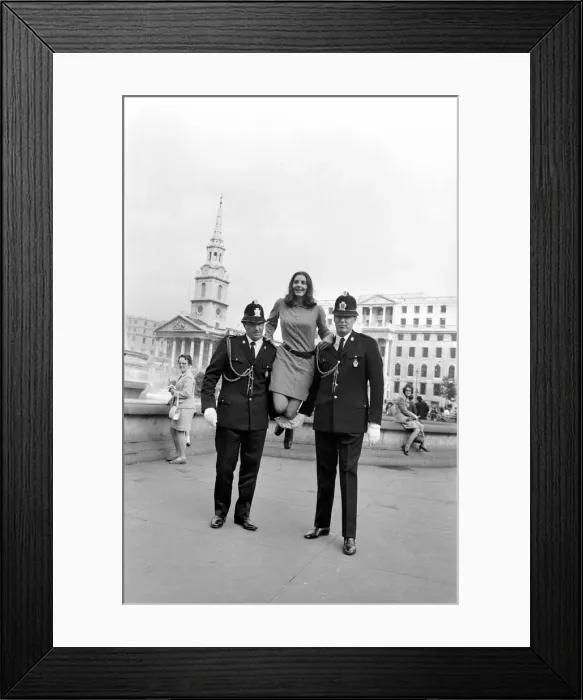 Framed Print : Woman being held up by two policemen in Trafalgar Square, London. October 1969 Z10351-001 Framed Print : Woman being held up by two policemen in Trafalgar Square, London. October 1969 Z10351-001