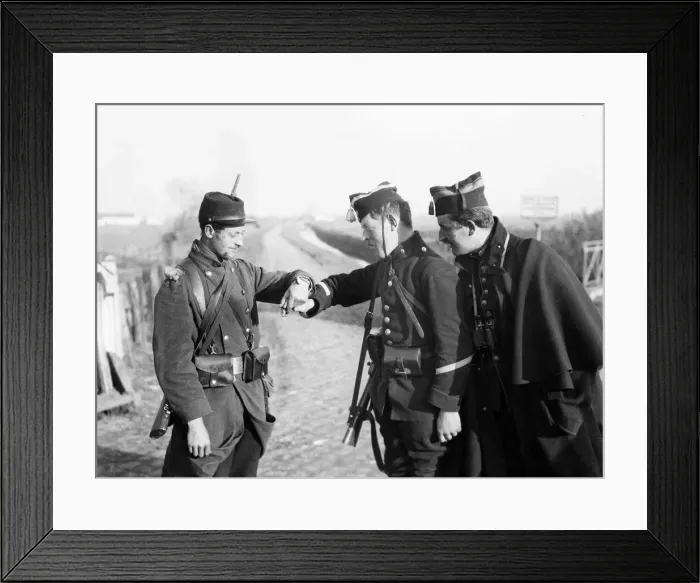 Framed Print : Belgian soldiers reading the identification disc which this French soldier has placed Framed Print : Belgian soldiers reading the identification disc which this French soldier has placed