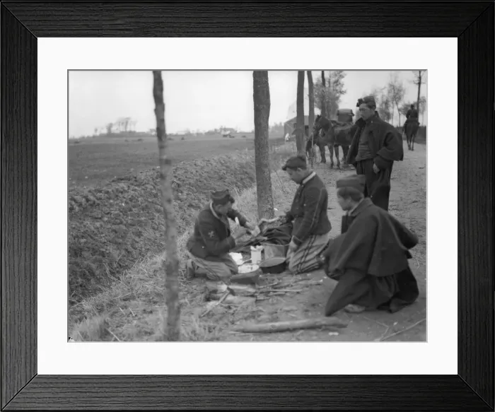 Framed Print : Belgian soldiers seen here preparing a chicken for the pot during a respite in the recent