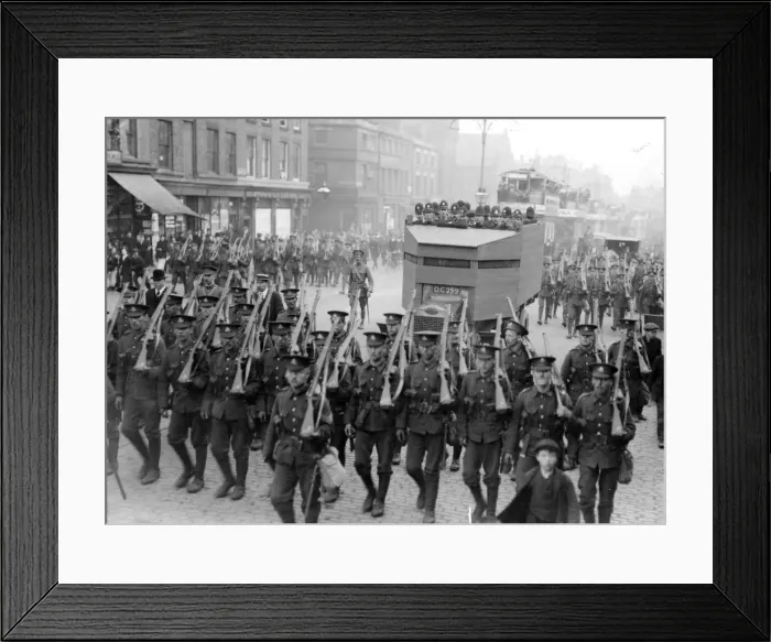 Framed Print : Police and military march ahead of a convoy of buses through the streets of Liverpool Framed Print : Police and military march ahead of a convoy of buses through the streets of Liverpool
