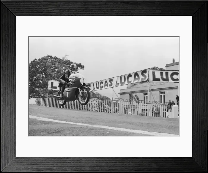 Framed Print : TT Races 250cc Lightweight International. Tarquinio Provini goes over Ballaugh Framed Print : TT Races 250cc Lightweight International. Tarquinio Provini goes over Ballaugh