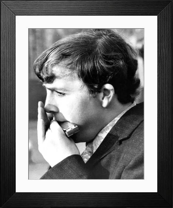 Framed Print : A young man playing the Harmonica in September 1971