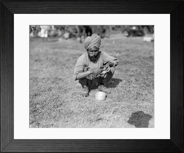 Framed Print : Indian soldier eating a chapatti during his stay at the Indian army rest camp on the race