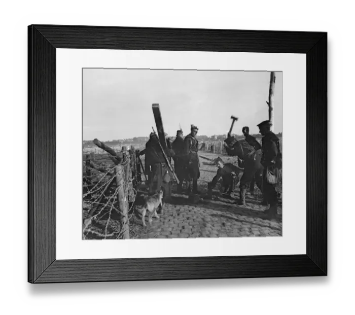 Framed Print : Retreating Belgian and Royal Marines errecting a barbed wire entanglement across the road