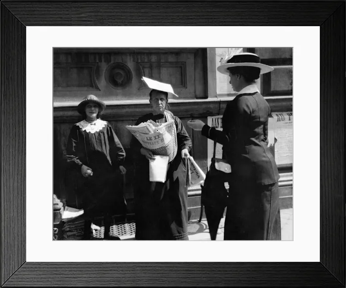 Framed Print : Woman newspaper vendor in Brussels wears a paper on her head as a impomptu sun hat Framed Print : Woman newspaper vendor in Brussels wears a paper on her head as a impomptu sun hat