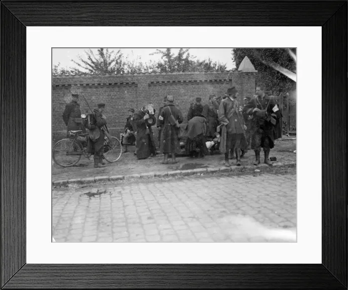 Framed Print : Battle of Hofstade. Priests attended to an injured soldier as a cycle patrol set out Framed Print : Battle of Hofstade. Priests attended to an injured soldier as a cycle patrol set out