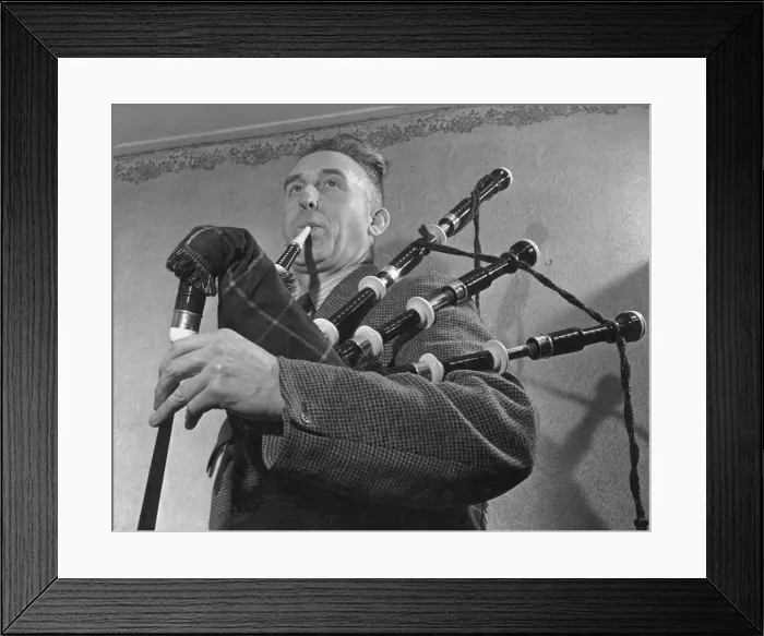 Framed Print : Bagpip tutir and expert Mr McCauley testing one of the new bagpipes made a London firm