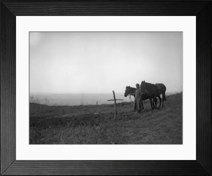 Framed Print : A lone Russian soldier stands by a mass grave in Galicia where the bodies of fifty