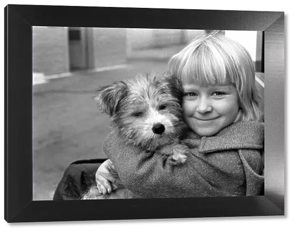 Cute children and Animals: Young girl holding her puppy dog. January 1980 80-00007