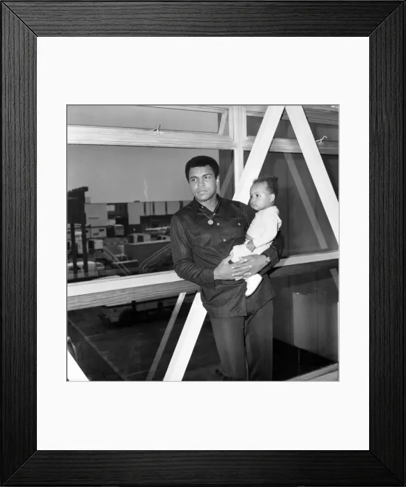 Framed Print : Mohammad Ali with baby Hanna at Heathrow Airport today. August 1977 77-04380-003 Framed Print : Mohammad Ali with baby Hanna at Heathrow Airport today. August 1977 77-04380-003