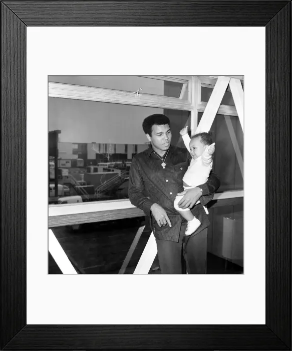 Framed Print : Mohammad Ali with baby Hanna at Heathrow Airport today. August 1977 77-04380-002